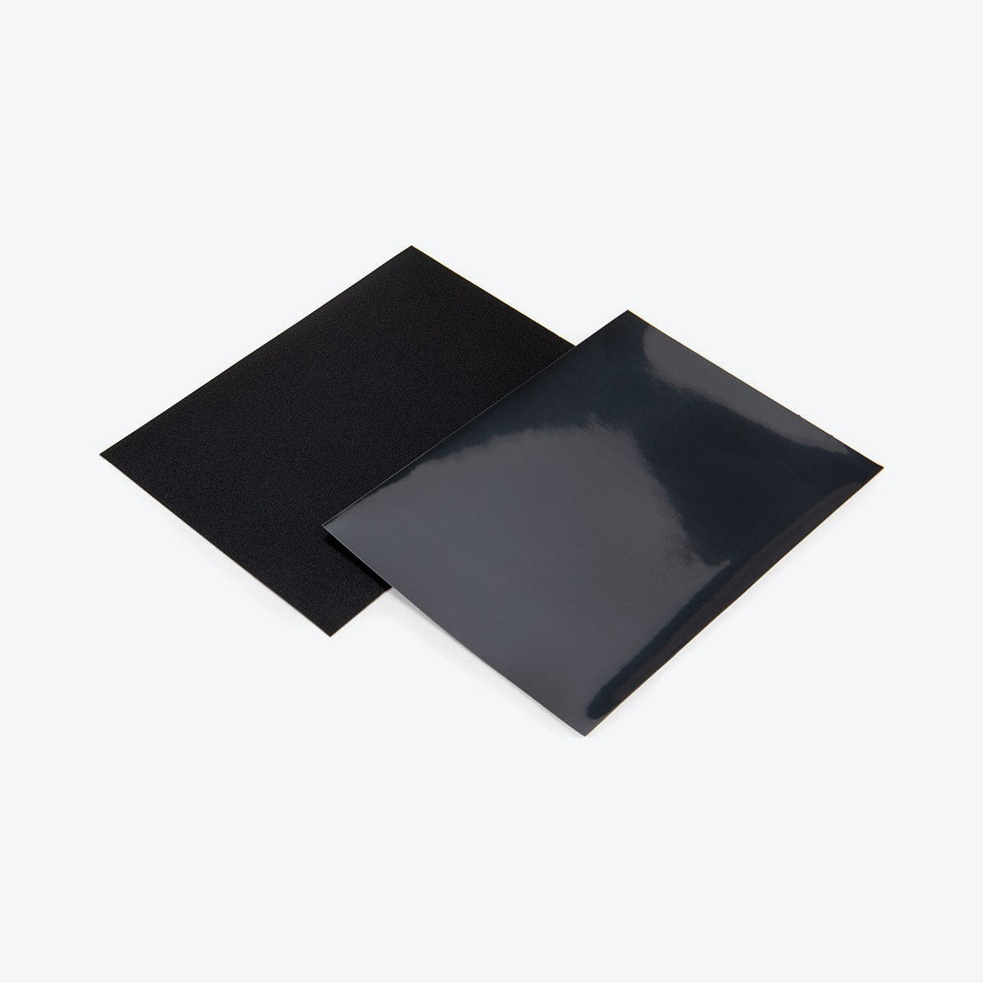 Two black card sleeves, one showing the matte back and one showing the glossy front
