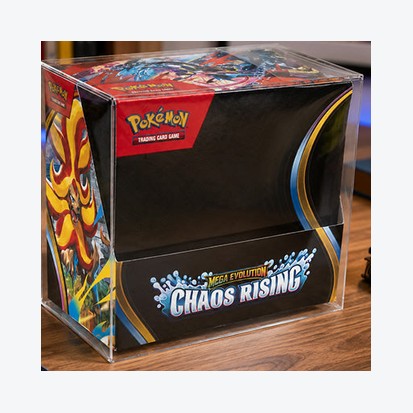 Clear protector fitted over a sealed booster box on a wooden desk