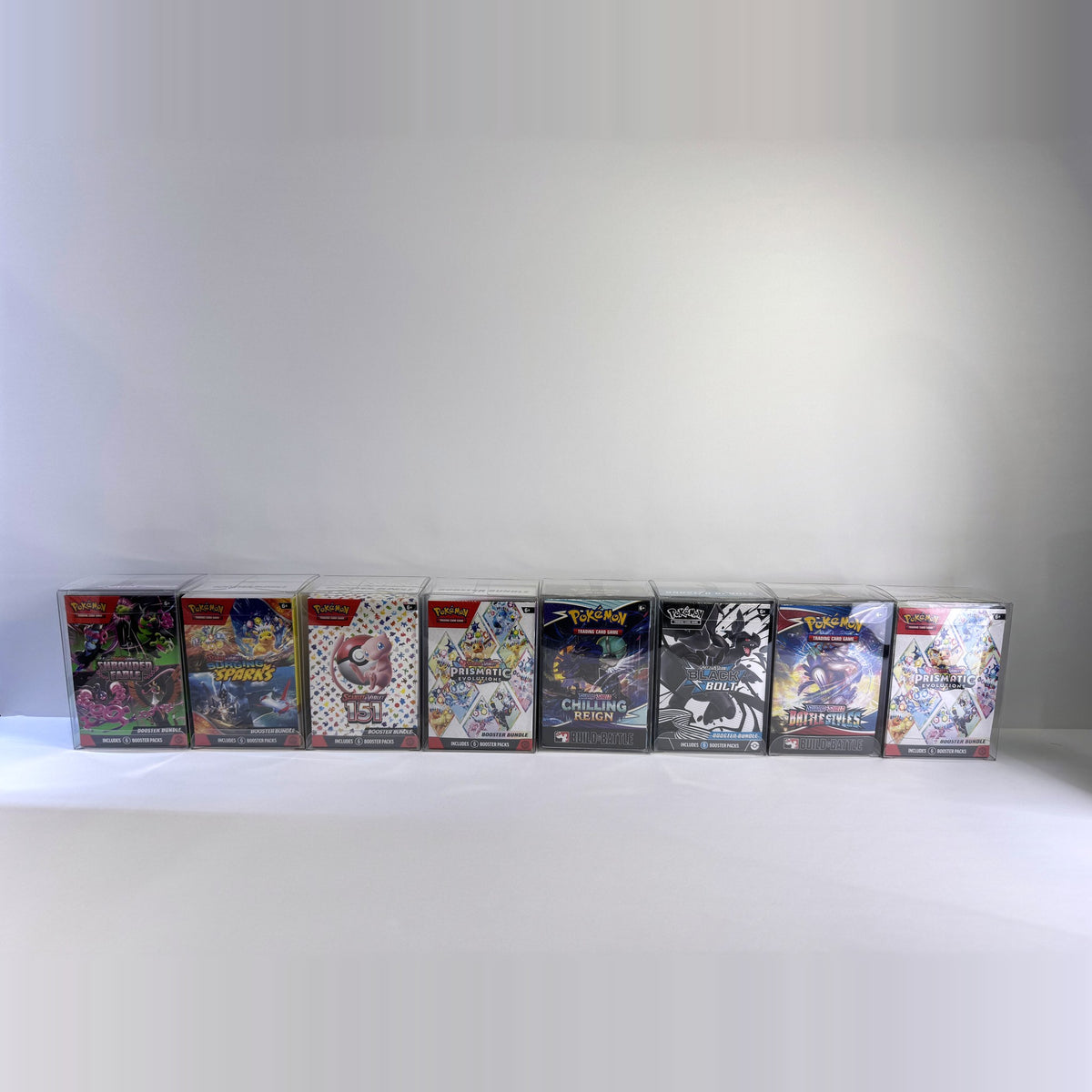 Row of eight booster bundles in clear protectors
