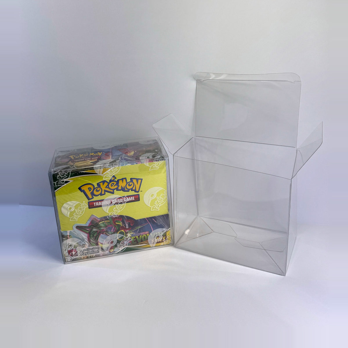 Booster box protector with flaps open next to a protected box