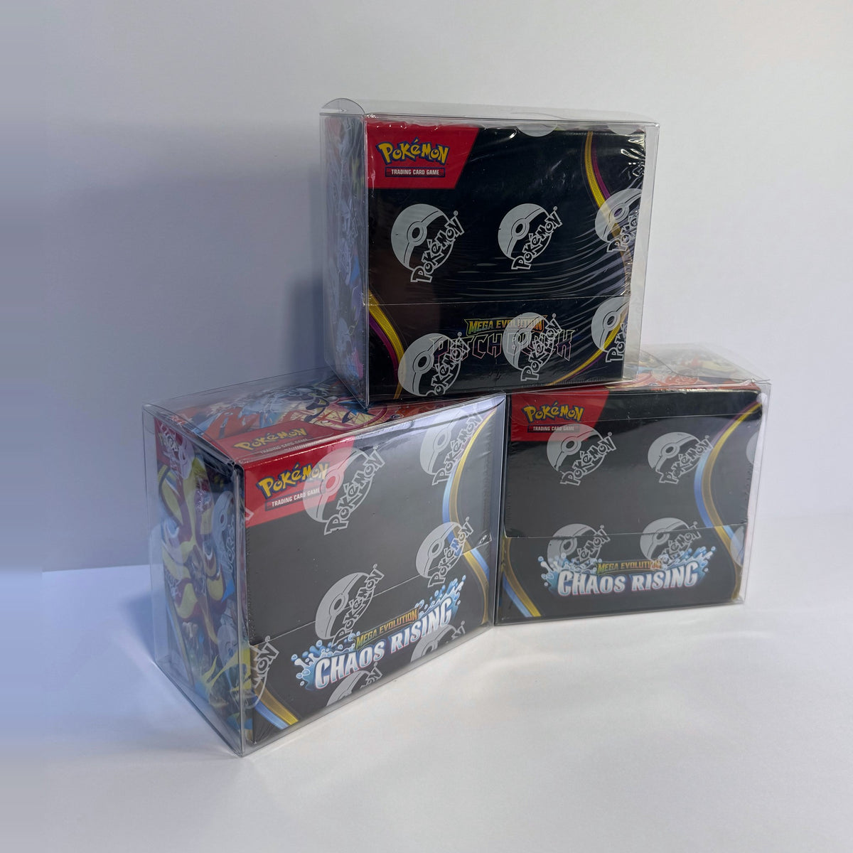 Three booster boxes in clear protectors stacked